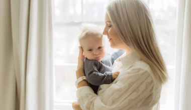 Mother holding her baby, depicting the close bond they've developed during her maternity leave before she has to return to work.